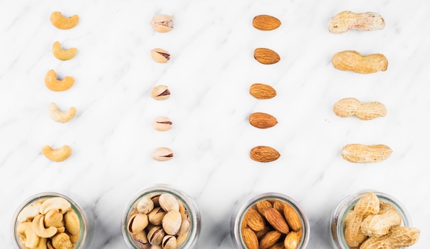 Fresh nut food in jar on marble surface