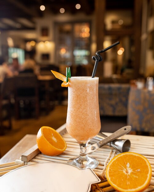 Fresh orange cocktail on the table with oranges