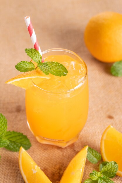 Fresh orange juice in glass with mint, fresh fruits. selective focus.