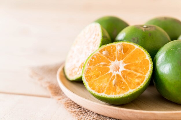 fresh orange on wood plate