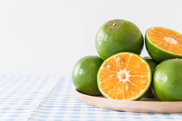 fresh orange on wood plate