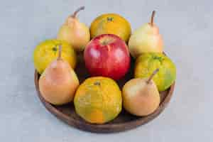 Free photo fresh organic fruits. apple, pear and tangerines.