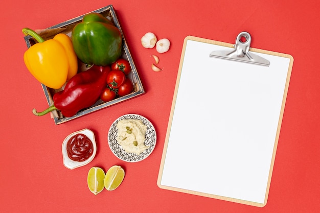 Fresh organic ingredients next to clipboard