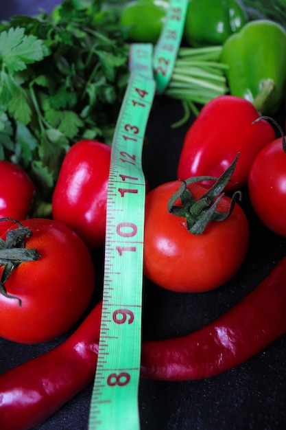 Fresh organic parsley, tomatoes, red peppers, green peppers, fennel, dill and cucumber with green centimeter top view, diet concept