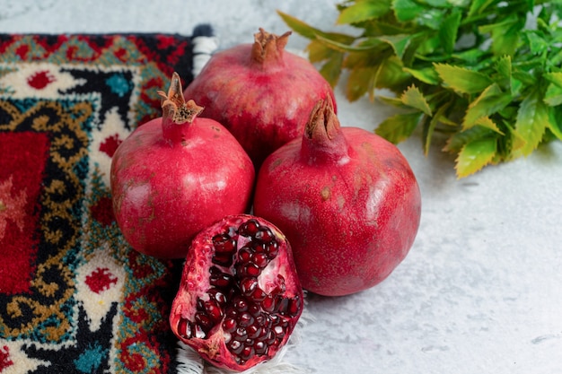 Fresh organic pomegranates over old traditional carpet. 