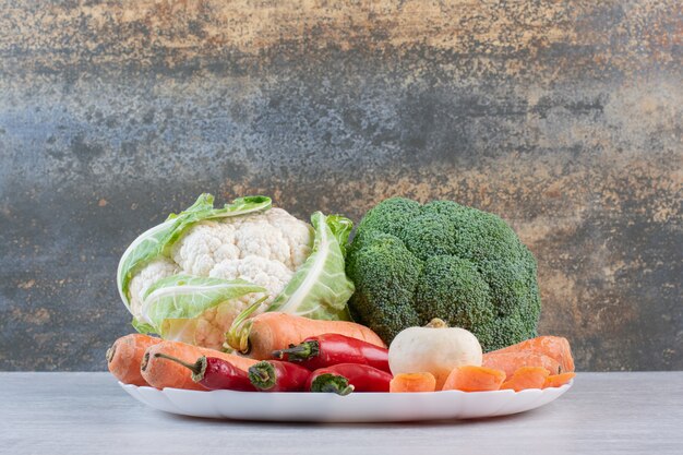 Fresh organic vegetables on white plate. High quality photo