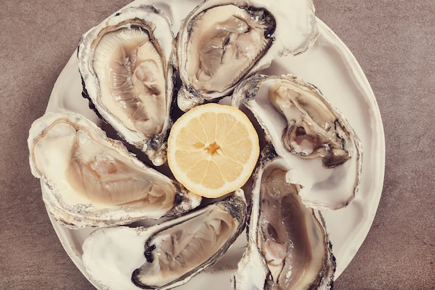 Free photo fresh oyster with lemon on a plate