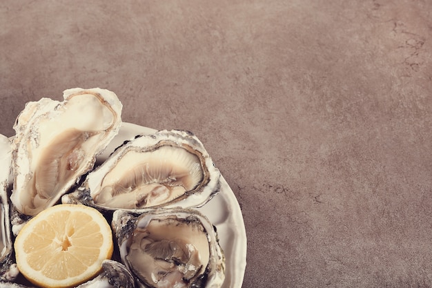 Free photo fresh oyster with lemon on a plate