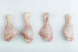 Free photo fresh raw chicken drumstick on white background.