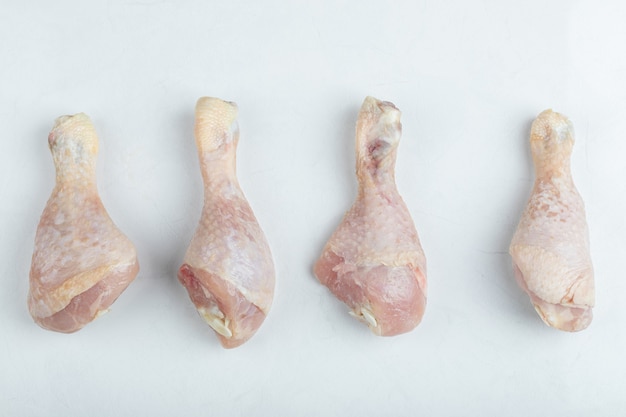 Free Photo fresh raw chicken drumstick on white background.