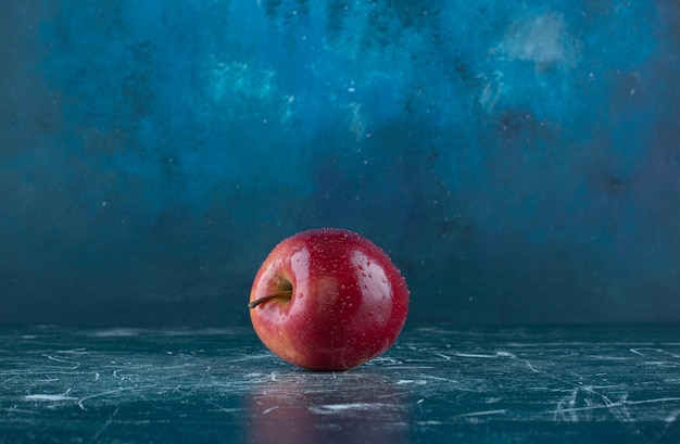 Fresh red apple on marble table. 