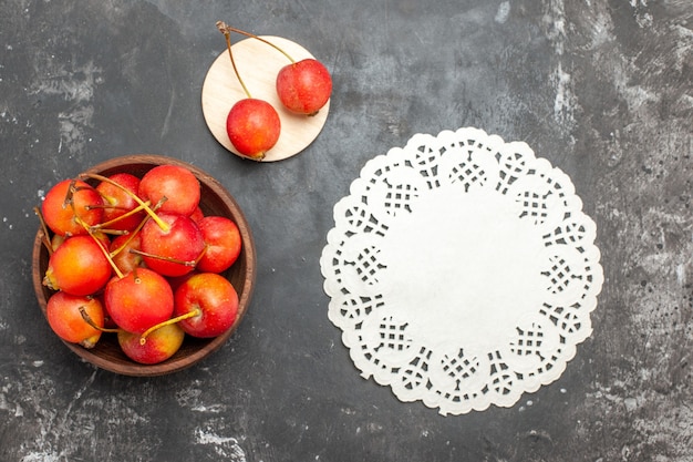 Free photo fresh red cherry fruit in a bowl on gray background