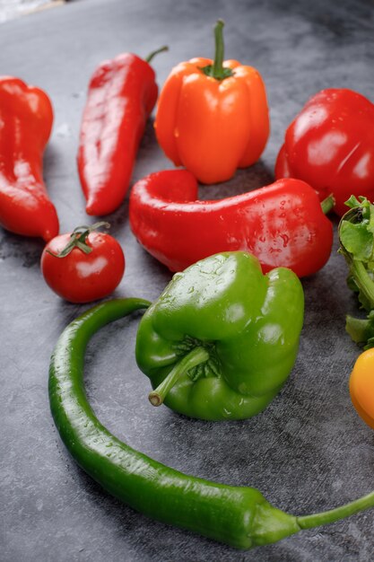 Fresh red and green peppers with water drops.