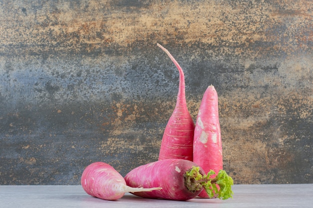 Free photo fresh red radishes on marble background. high quality photo