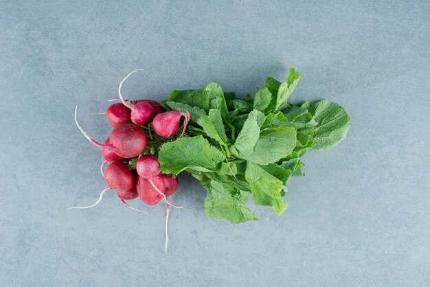 Fresh red turnips on marble.