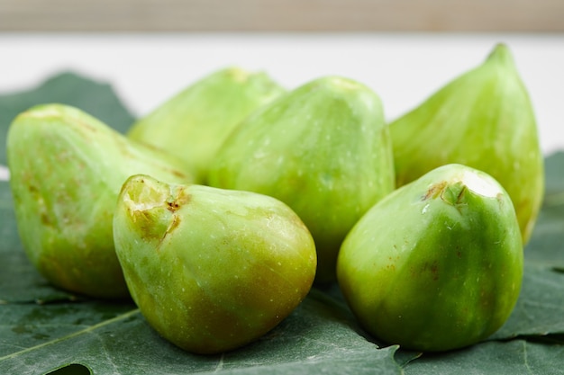 Fresh ripe green figs on the leaves. High quality photo