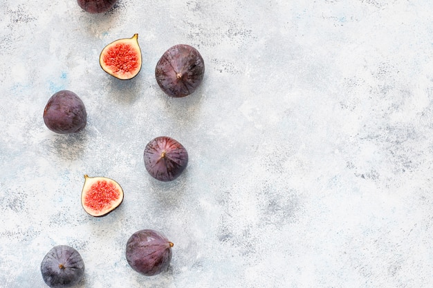 Fresh ripe purple figs on light,  top view