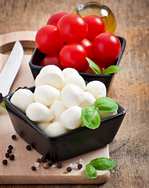 Fresh salad with cherry tomatoes, basil, mozzarella and black olives.