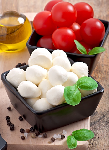 Fresh salad with cherry tomatoes, basil, mozzarella and black olives.