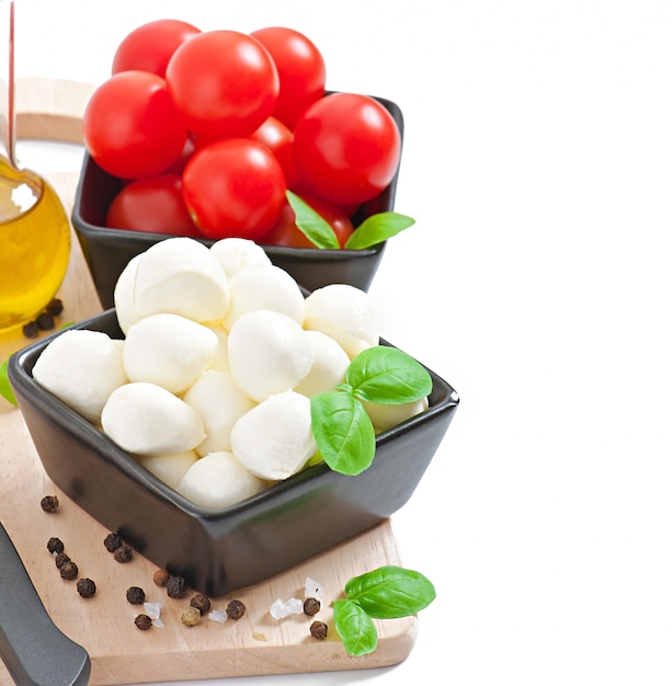 Fresh salad with cherry tomatoes, basil, mozzarella and black olives.