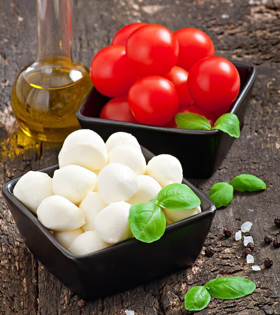 Fresh salad with cherry tomatoes, basil, mozzarella and black olives.