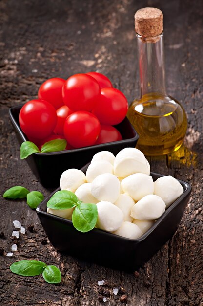 Fresh salad with cherry tomatoes, basil, mozzarella and black olives.