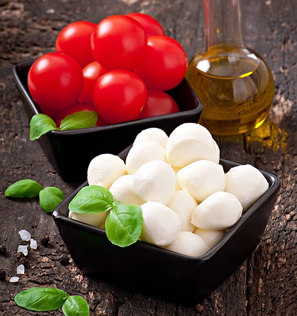 Fresh salad with cherry tomatoes, basil, mozzarella and black olives.