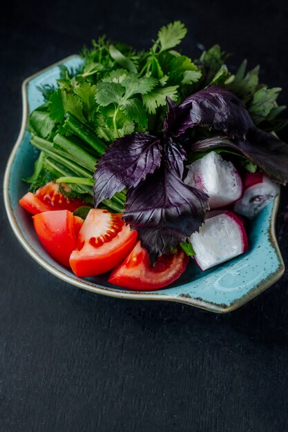 Fresh salad with tomatoes radishes and greens