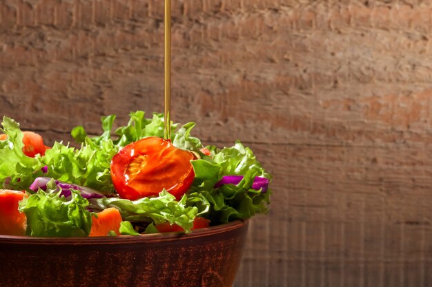 Fresh salad on wooden table