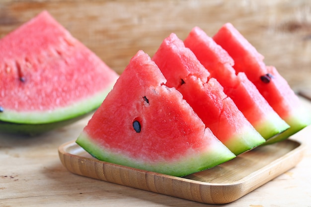 Fresh sliced watermelon on wooden background