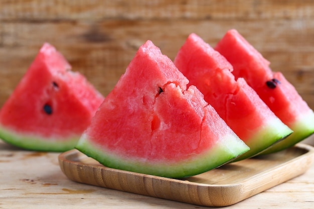 Fresh sliced watermelon on wooden background