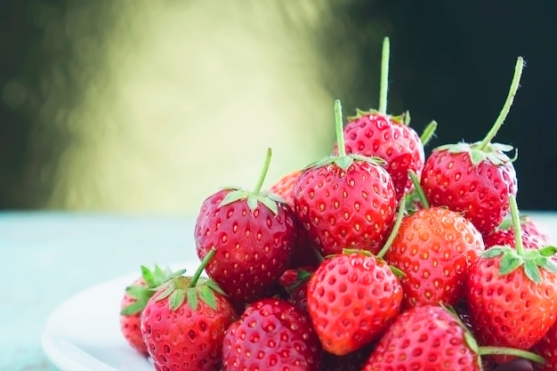 Fresh strawberries over golden gradient light background