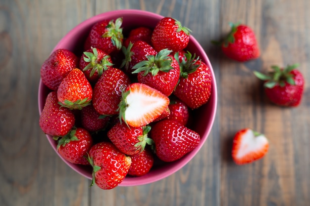 Fresh strawberries on wooden table.