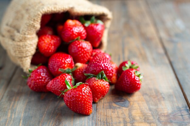 Fresh strawberries on wooden table.