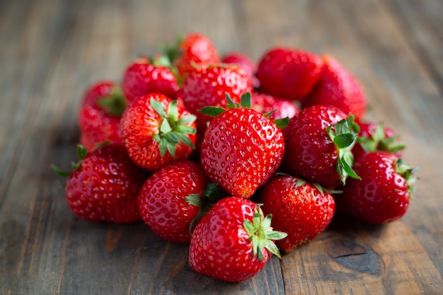 Fresh strawberries on wooden table.