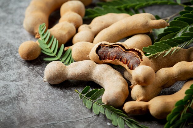 Fresh sweet ripe tamarind on dark surface