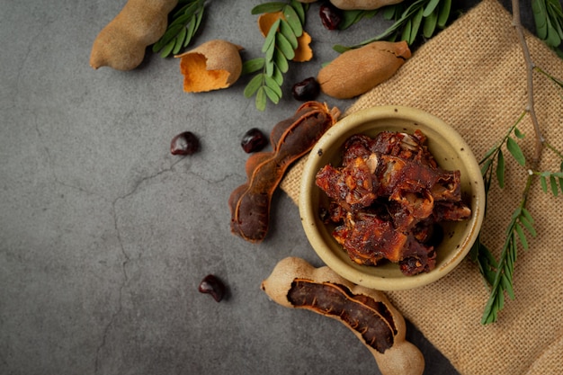 Fresh sweet ripe tamarind on dark surface