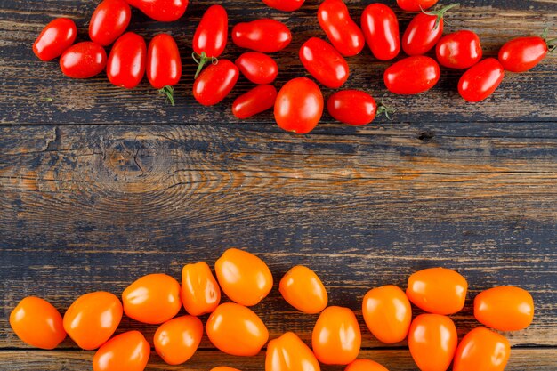 Fresh tomatoes on wooden table, flat lay.