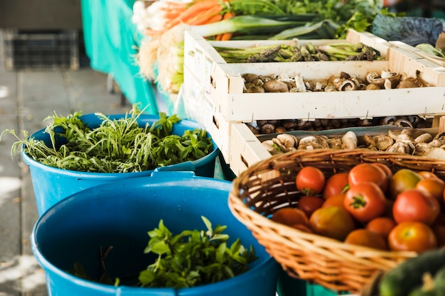 Free Photo fresh vegetable with mushroom in wooden crate at market stall