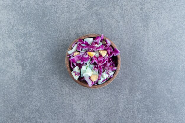 Fresh vegetables salad in wooden bowl.