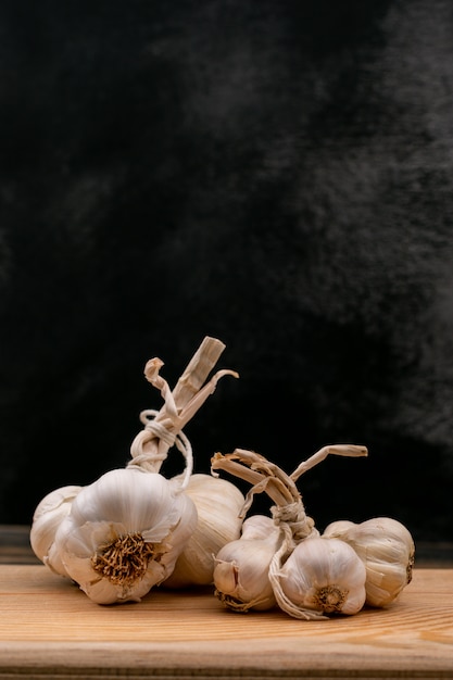 Fresh white garlics on wooden board