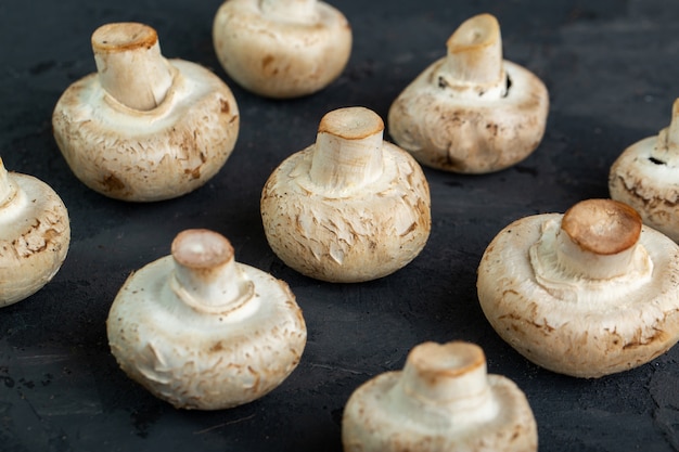 Fresh white mushrooms on black background