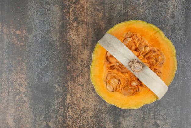 Fresh yellow pumpkin on marble background