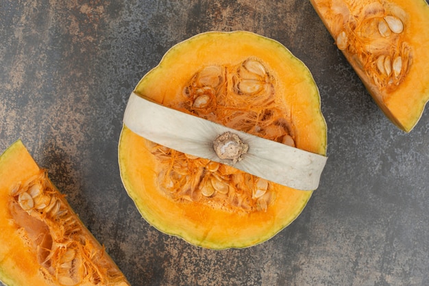 Fresh yellow pumpkin on marble surface