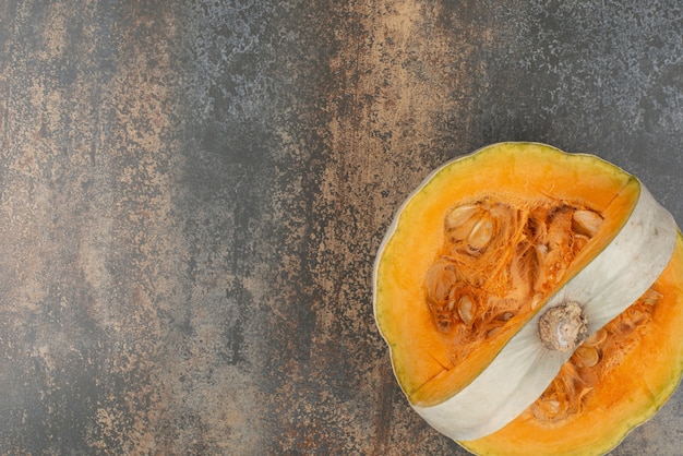 Fresh yellow pumpkin on marble surface