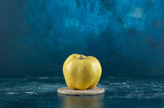 Fresh yellow quince on marble table. 