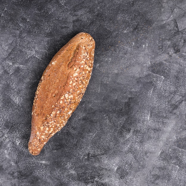 Free photo freshly baked multi-grain bread on black kitchen counter