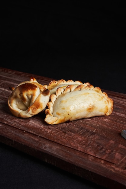 Freshly baked pies on the wooden tray