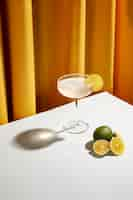 Free photo freshly cocktail drink with salty rim and lemon slices over white desk