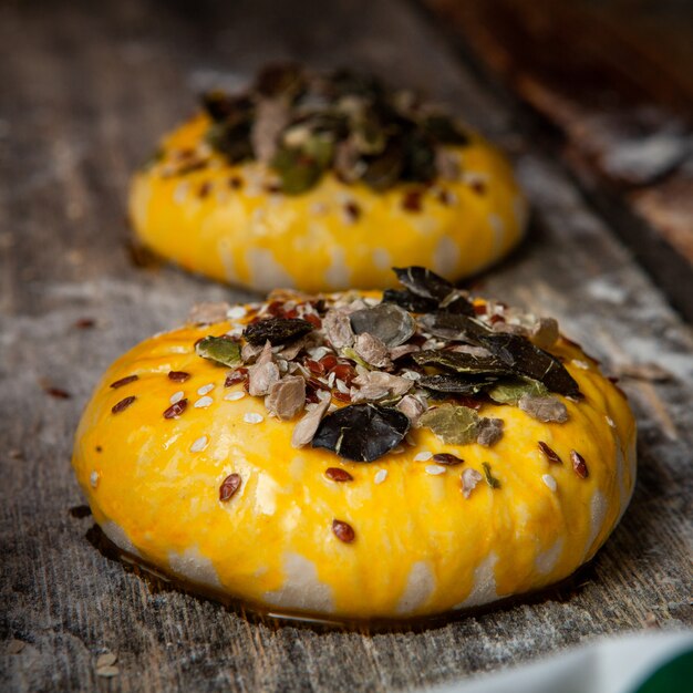 Freshly rolled dough decorated with spices close-up